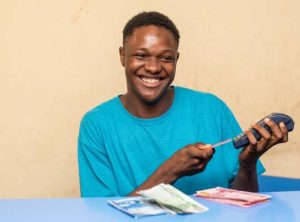 An African male making a payment on a pos terminal